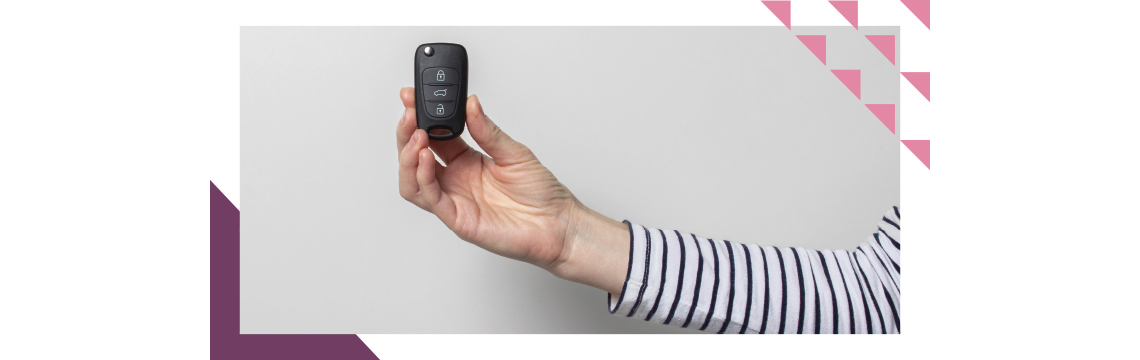 arm with a long-sleeved striped shirt holding wireless car key